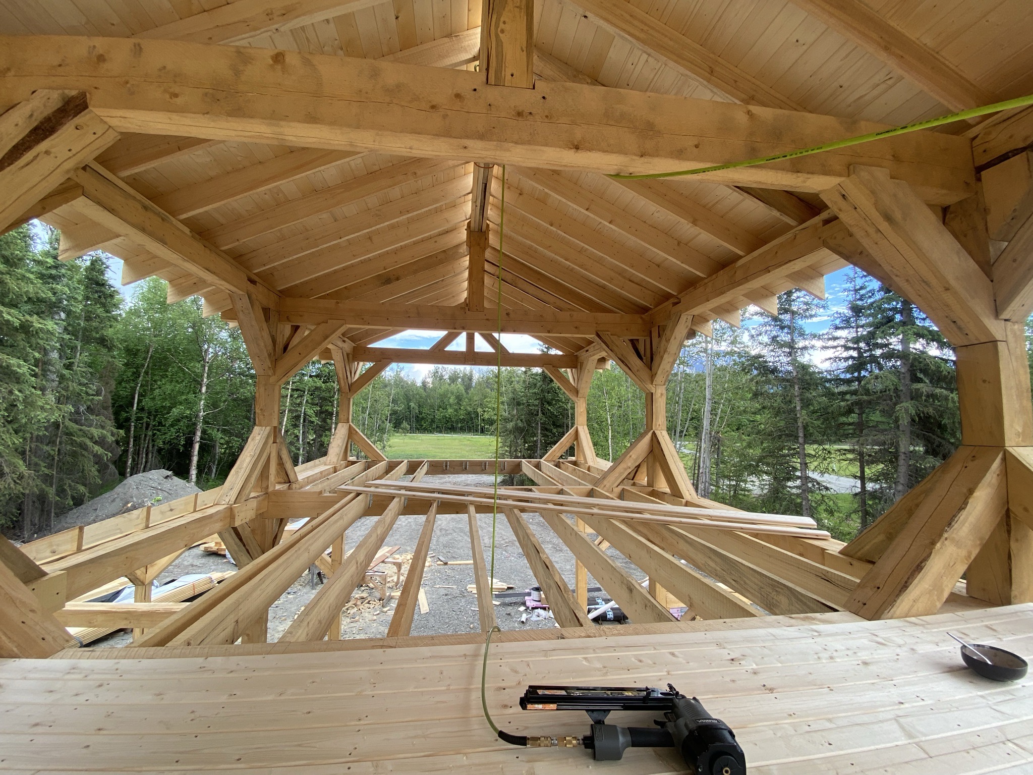 Stacks of fresh-milled rough-cut 8x8 timber beams staged on site