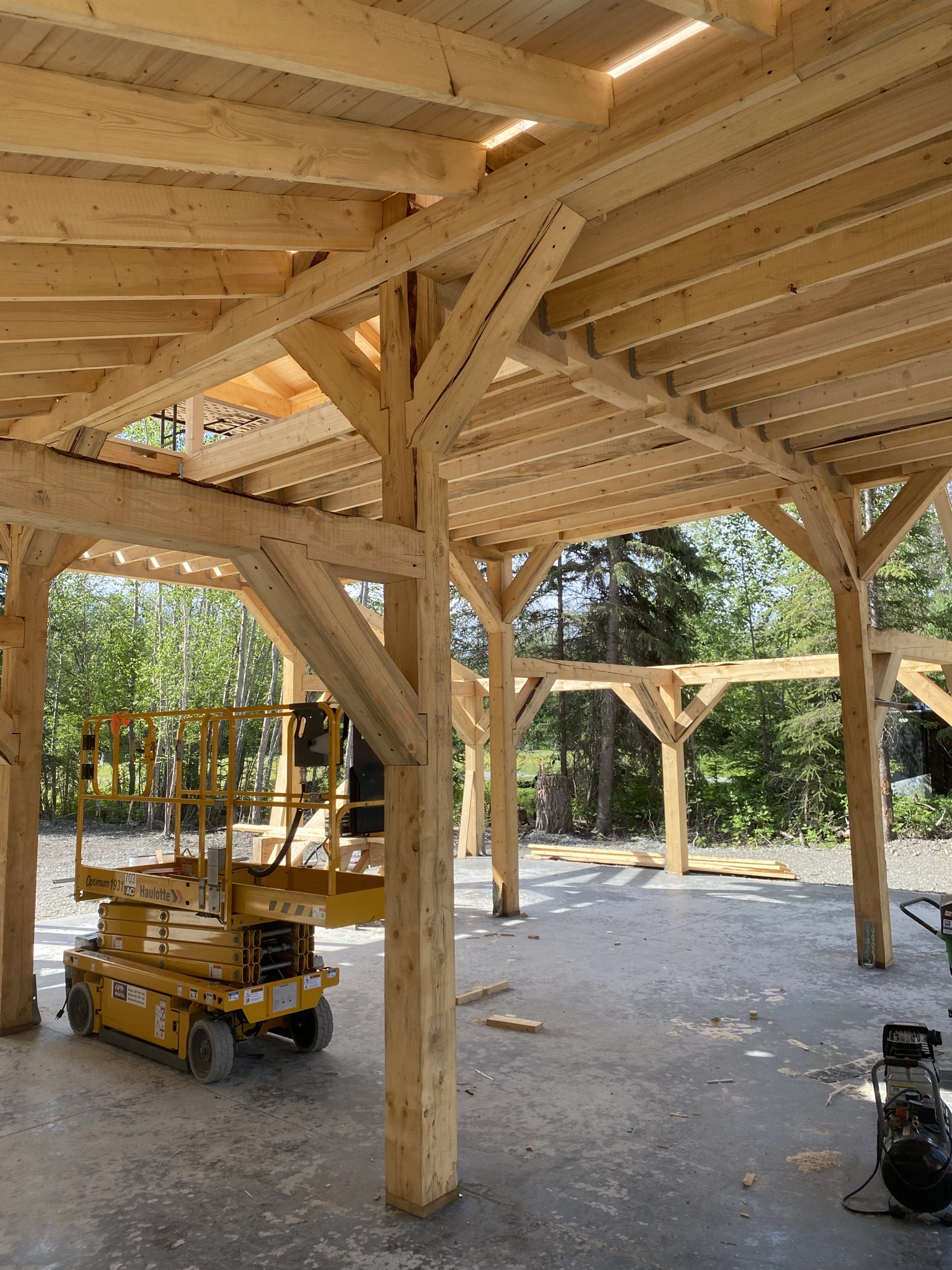 Worm-drive Skilsaw cutting a heavy rough-cut timber beam on site sawhorses