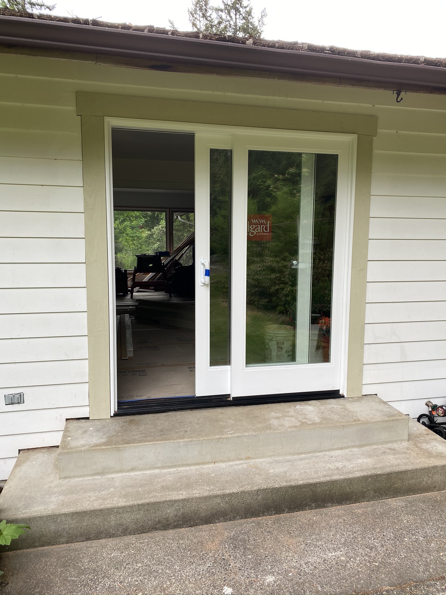 New rear sliding patio door installed during the Issaquah remodel, replacing the original slider and bringing more daylight into the open floor plan