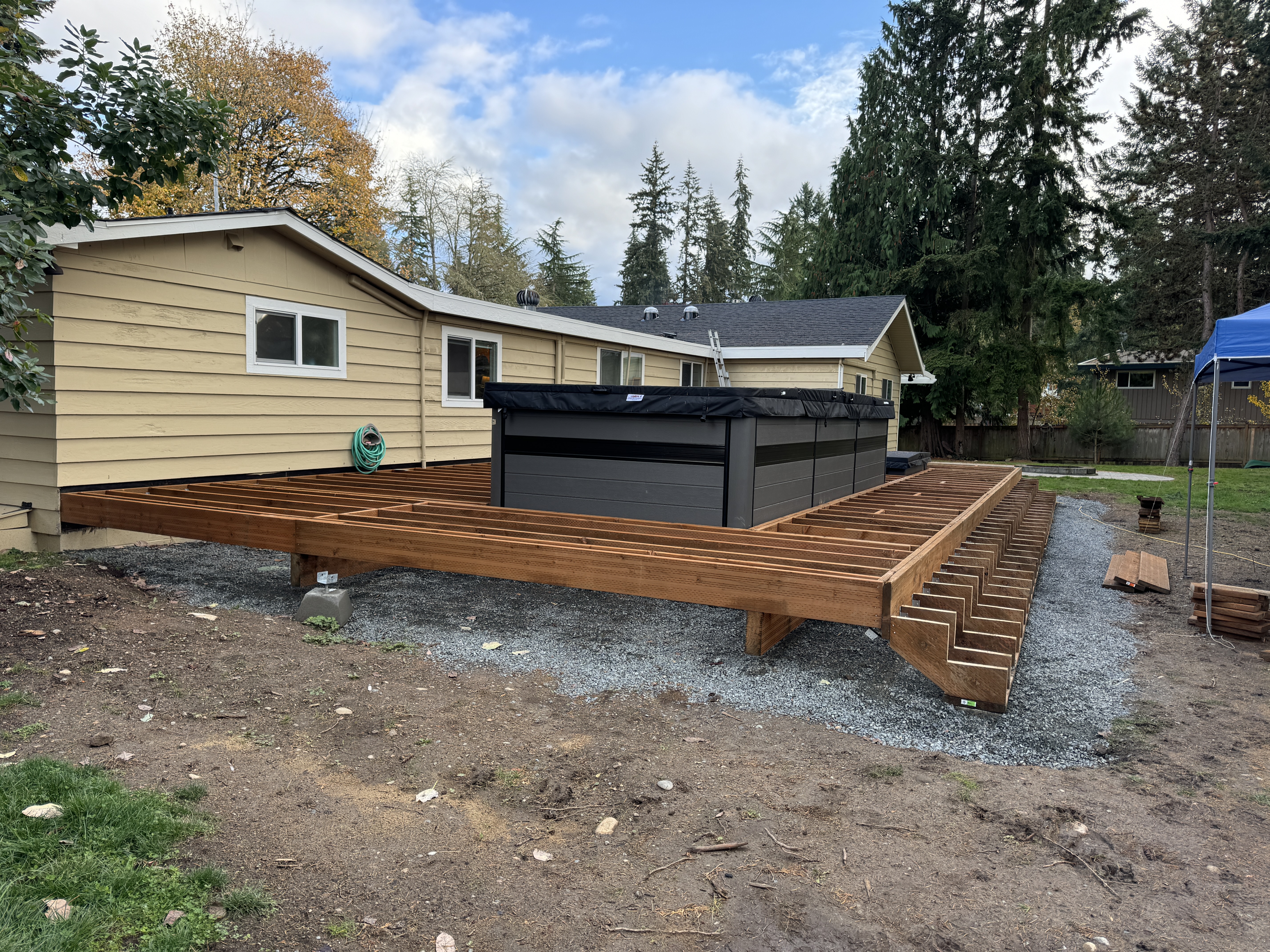 Framed composite deck joists and concrete footings with the swim spa set in place in a Kenmore backyard