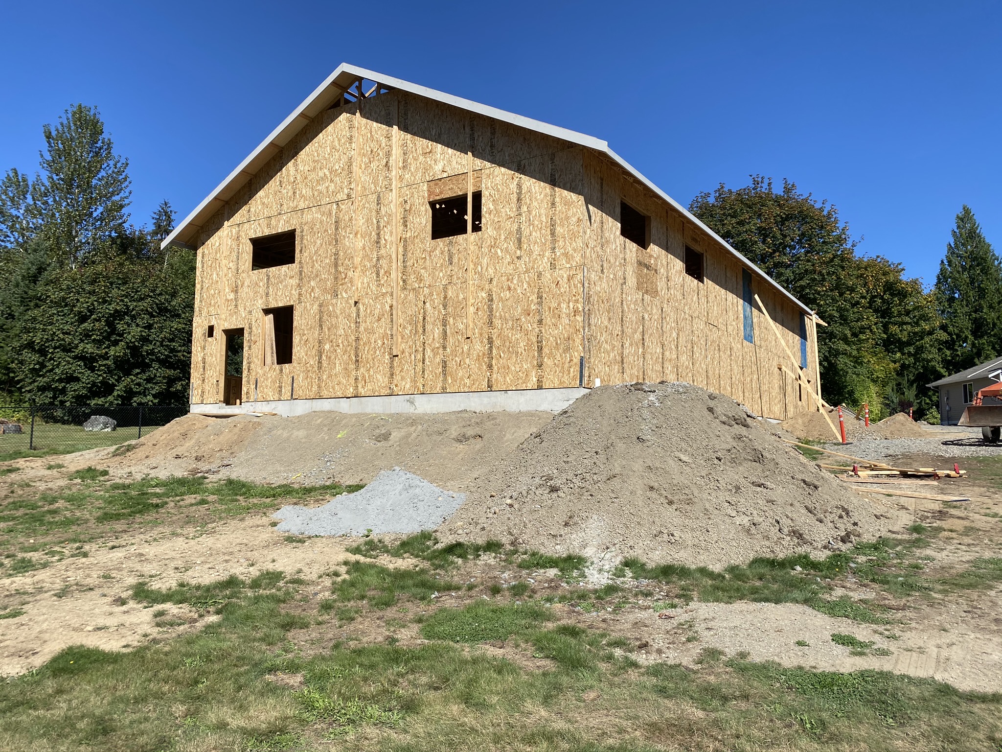 New commercial shop fully sheathed and roofed during dry-in phase of ground-up construction in Monroe Washington