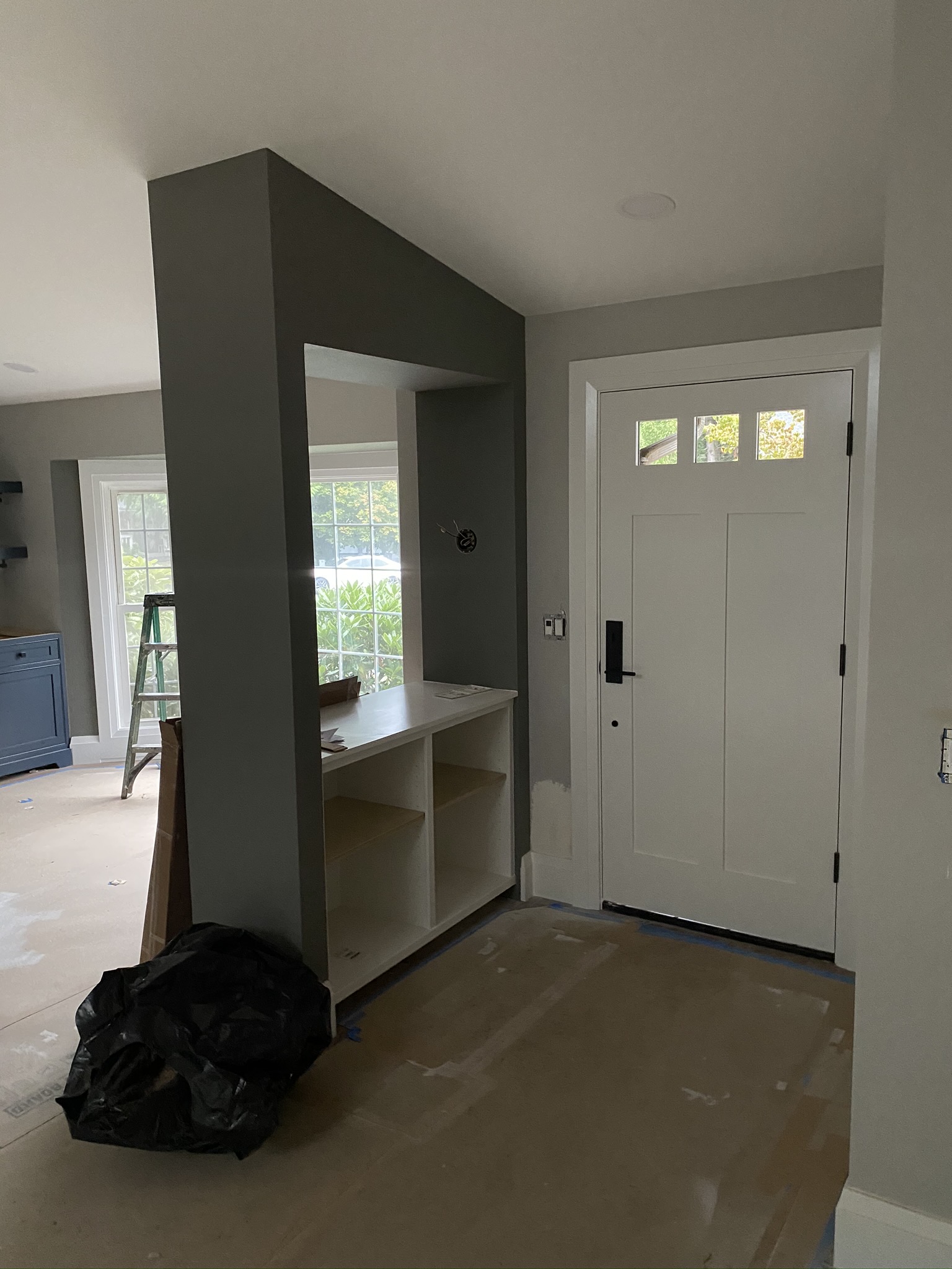 New resized front entry door with built-in bench and shelving