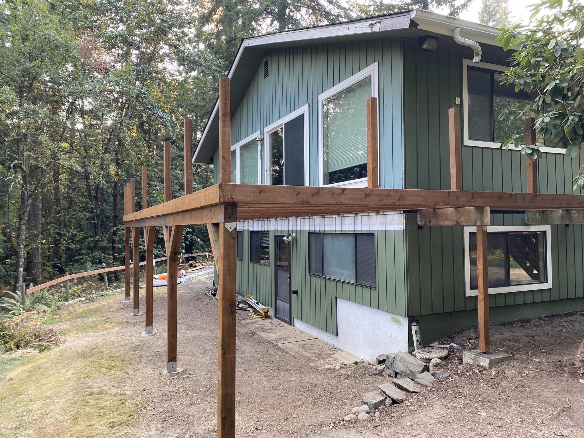 Side elevation of the new deck structure with repaired siding and trim