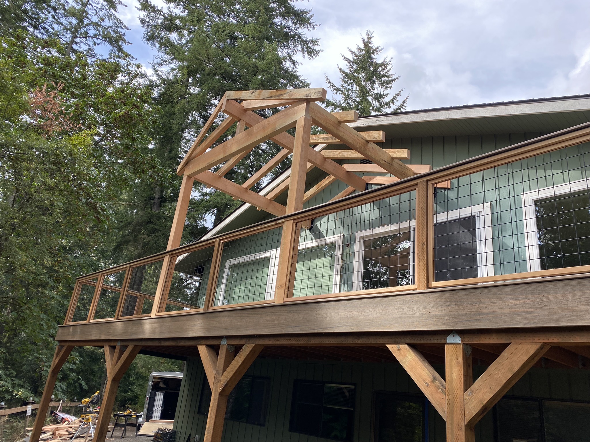 Cedar patio cover and hog wire railing taking shape during week three of the build