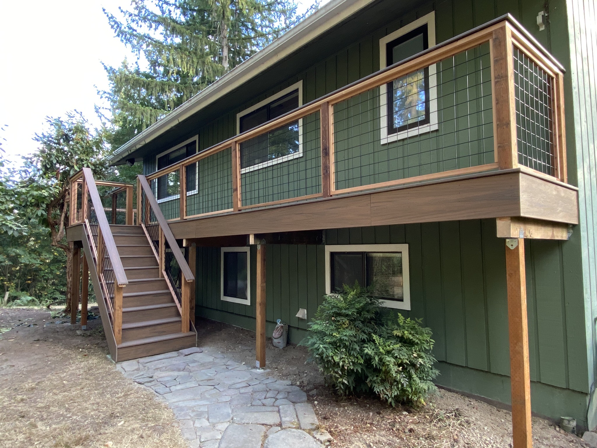 Wide view of the finished elevated composite deck and cedar patio cover in Carnation WA
