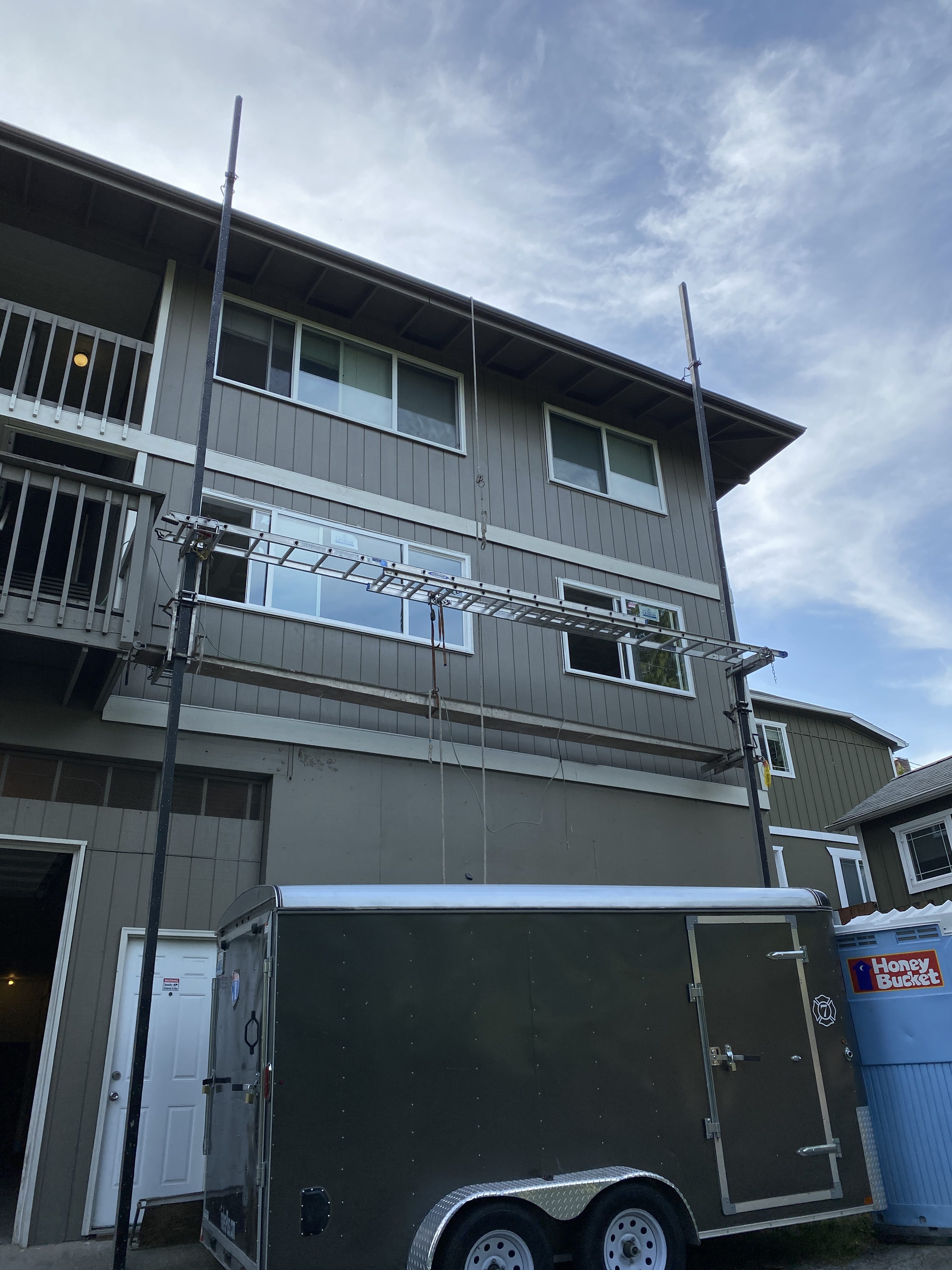 Crew replacing exterior windows on a Kirkland six-unit apartment building during a value-add remodel