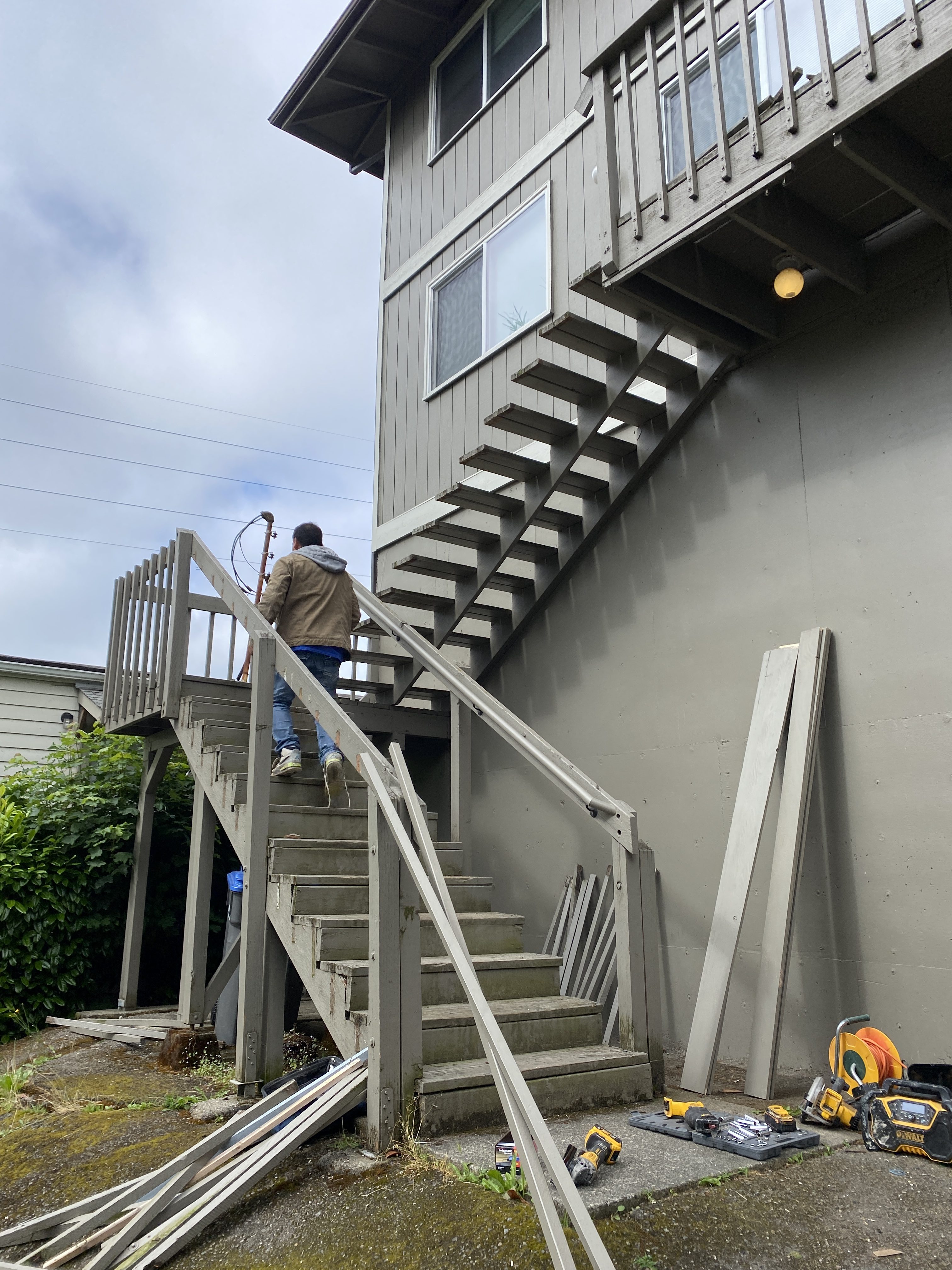Original exterior stair railings being replaced for code compliance at a Kirkland multiplex