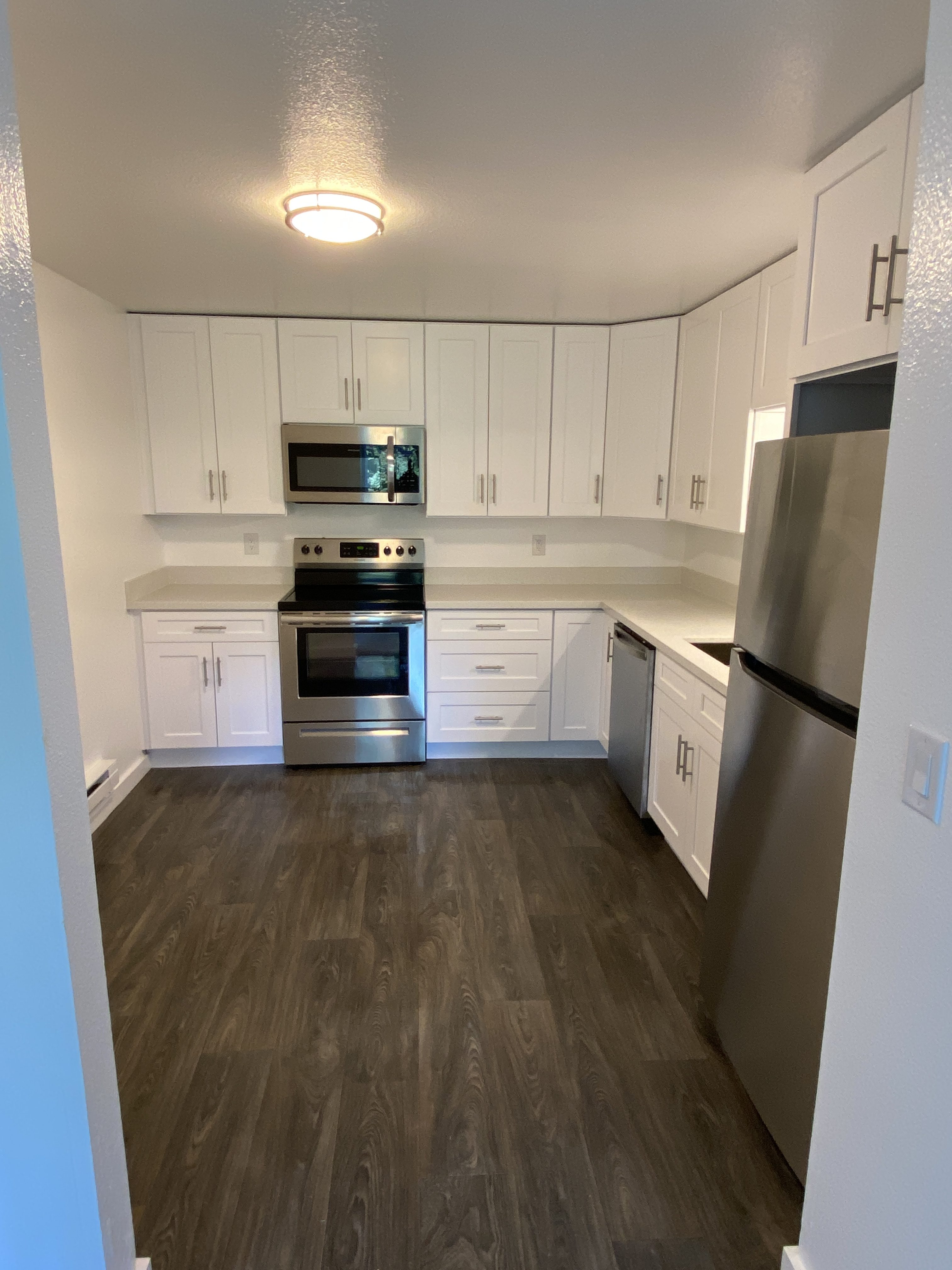 New white vanity and mirror in a remodeled Kirkland rental bathroom